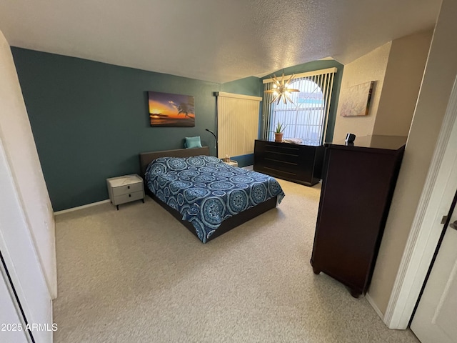 carpeted bedroom featuring a textured ceiling and a notable chandelier