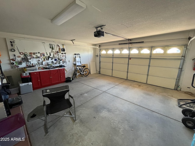 garage with a garage door opener and a workshop area