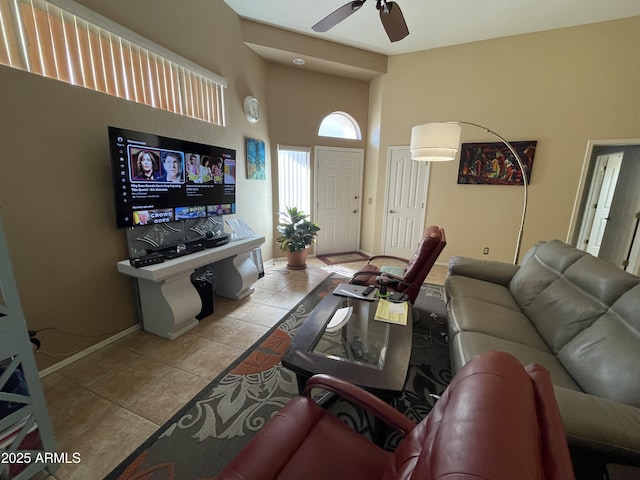 tiled living room featuring a towering ceiling and ceiling fan