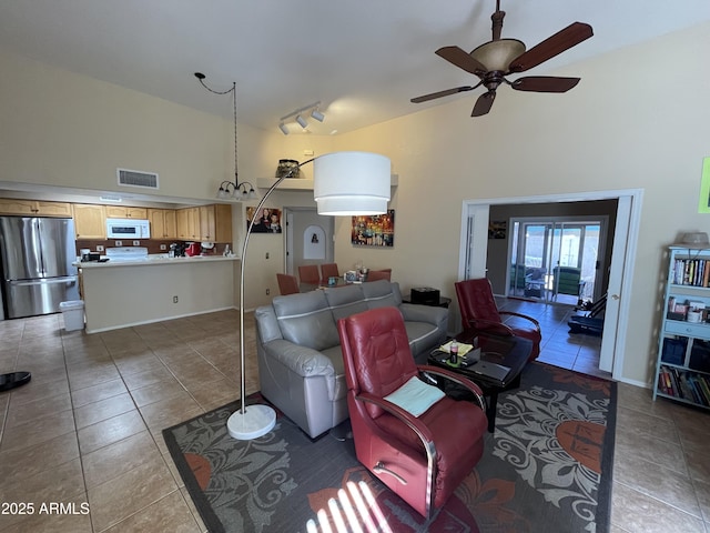 living room featuring tile patterned flooring, track lighting, high vaulted ceiling, and ceiling fan