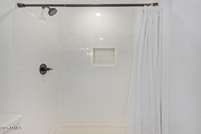 full bathroom featuring toilet and a stall shower