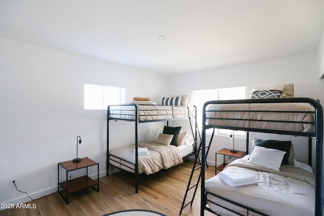 bedroom with baseboards and wood finished floors