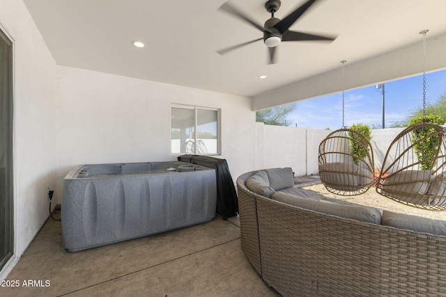 view of patio / terrace featuring outdoor lounge area, a hot tub, and a ceiling fan