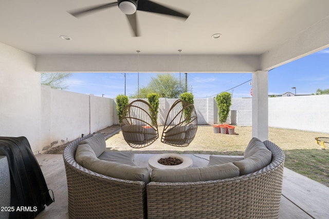 view of patio / terrace with a fire pit, a fenced backyard, and a ceiling fan