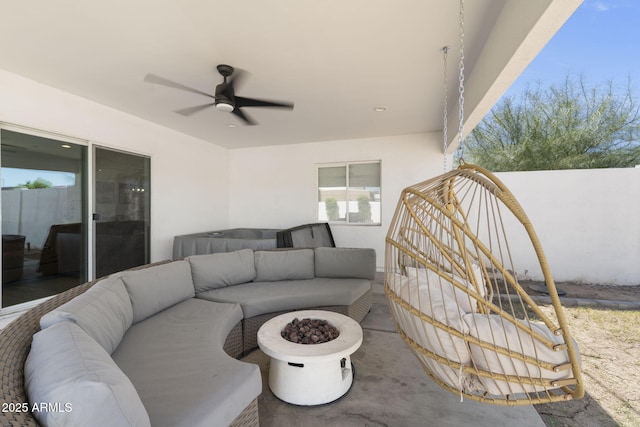 view of patio featuring ceiling fan and an outdoor living space with a fire pit