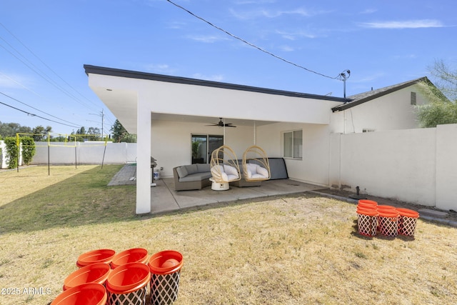 back of house featuring a patio, ceiling fan, a fenced backyard, a lawn, and stucco siding