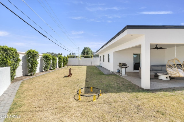 view of yard with a fenced backyard, a patio, and a ceiling fan