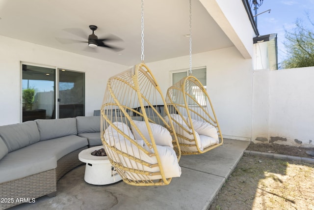 view of patio with an outdoor living space with a fire pit and ceiling fan