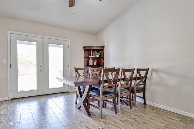 7125 W Canterbury Dr, Peoria, AZ 85345 - dining space with french doors, ceiling fan, light wood-type flooring, baseboards, and lofted ceiling