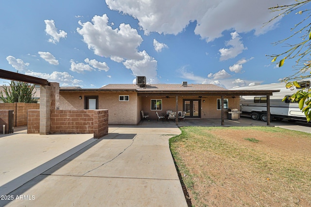 7125 W Canterbury Dr, Peoria, AZ 85345 - back of property with french doors, a ceiling fan, fence, central AC unit, and a patio area