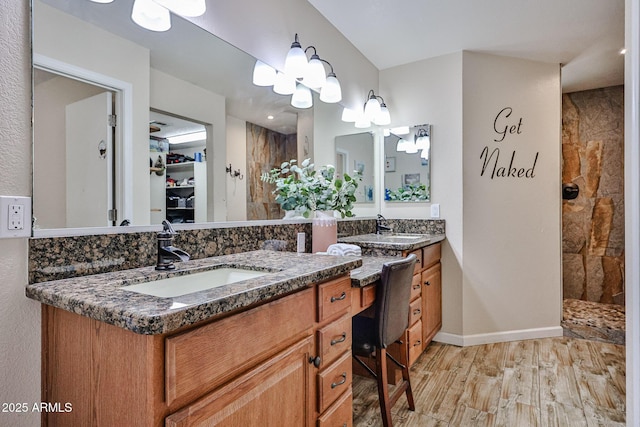 7125 W Canterbury Dr, Peoria, AZ 85345 - full bath featuring a tile shower, double vanity, wood finished floors, and baseboards
