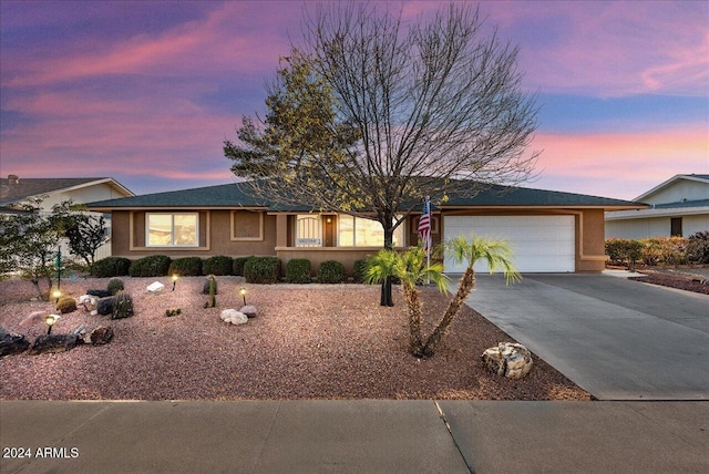 ranch-style home featuring a garage