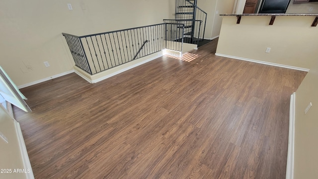 5628 S 21st Pl, Phoenix, AZ 85040 - unfurnished living room featuring baseboards, dark wood-style flooring, and stairs