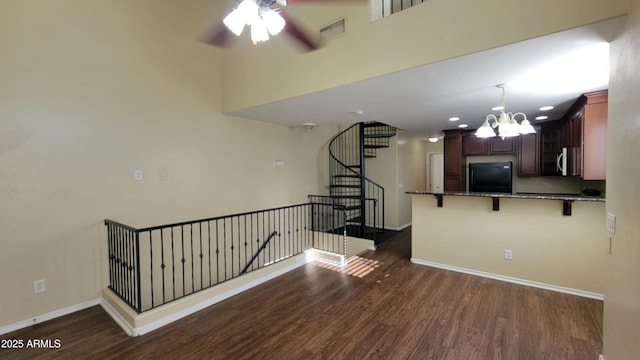 5628 S 21st Pl, Phoenix, AZ 85040 - kitchen featuring black refrigerator, dark wood-style floors, baseboards, a kitchen bar, and recessed lighting