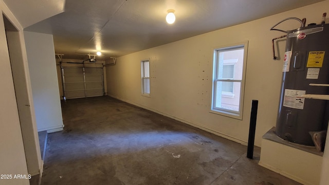5628 S 21st Pl, Phoenix, AZ 85040 - garage featuring electric water heater, a garage door opener, and baseboards