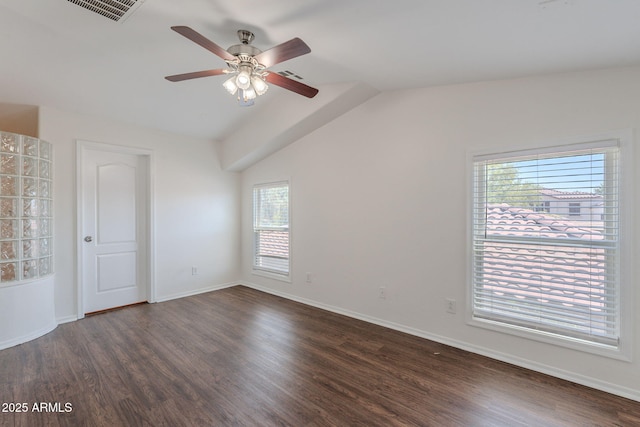 5628 S 21st Pl, Phoenix, AZ 85040 - unfurnished bedroom featuring dark wood-type flooring, multiple windows, baseboards, and vaulted ceiling