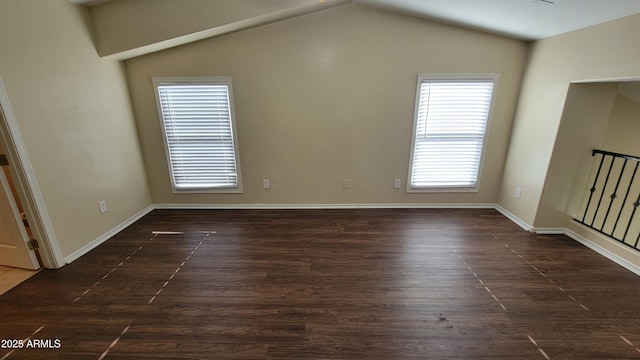 5628 S 21st Pl, Phoenix, AZ 85040 - empty room with vaulted ceiling, dark wood finished floors, and baseboards