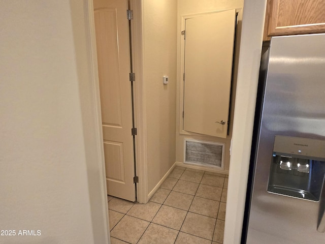 corridor with light tile patterned flooring