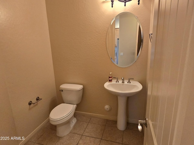 bathroom with tile patterned flooring and toilet