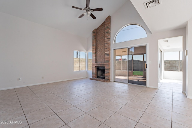 unfurnished living room featuring light tile patterned flooring, visible vents, a brick fireplace, and high vaulted ceiling