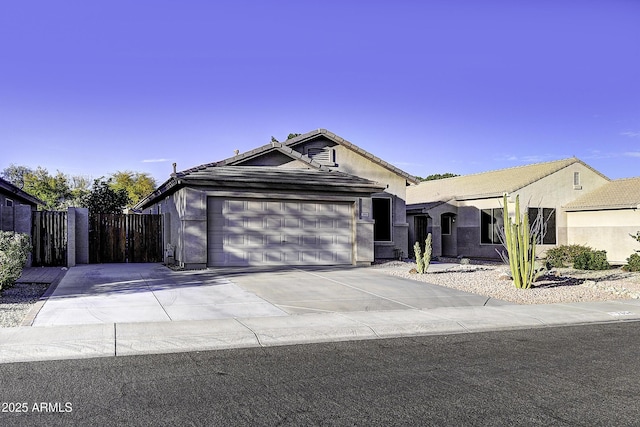 single story home featuring concrete driveway, fence, an attached garage, and stucco siding