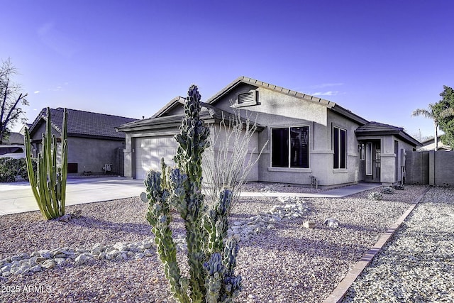 ranch-style home featuring a garage, concrete driveway, fence, and stucco siding