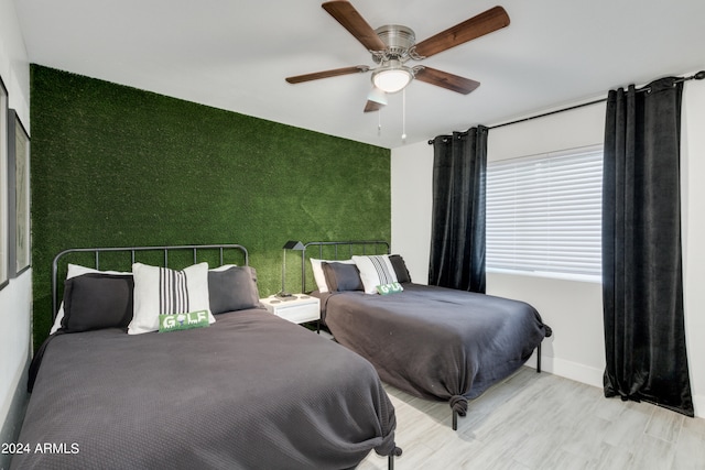 bedroom featuring ceiling fan and light wood-type flooring