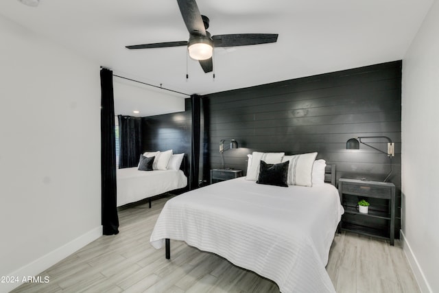 bedroom with light hardwood / wood-style floors and ceiling fan