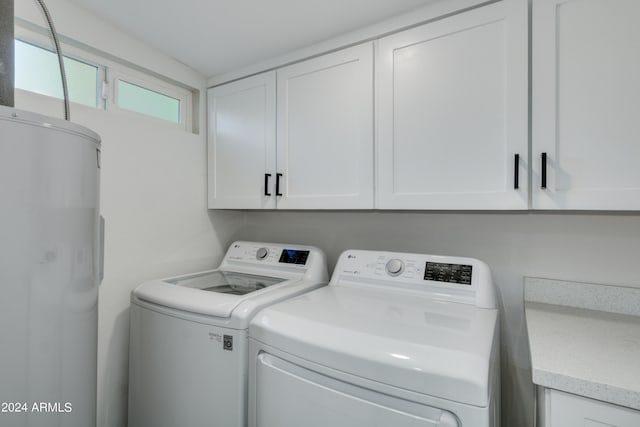 laundry area with washer and dryer and cabinets