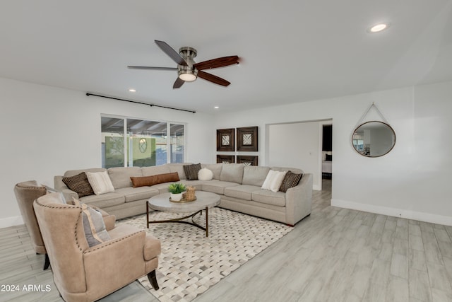 living room with ceiling fan and light hardwood / wood-style floors