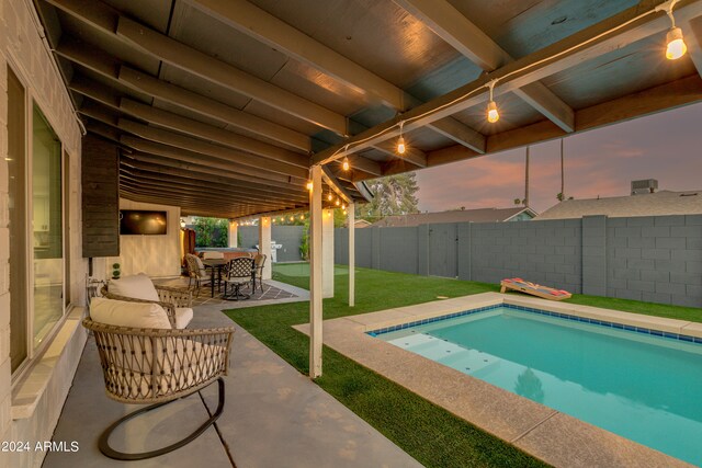 view of swimming pool with a yard and a patio