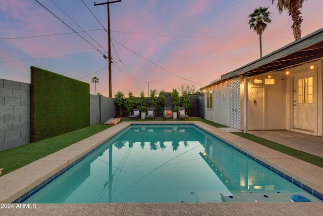 view of pool at dusk