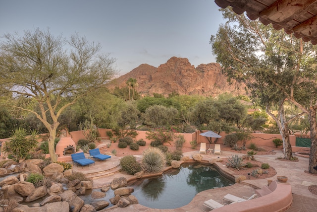 exterior space with a mountain view and a patio