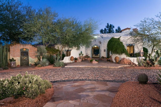 mediterranean / spanish home with a patio