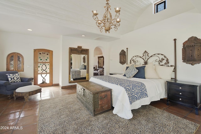 bedroom featuring a chandelier and dark tile patterned flooring