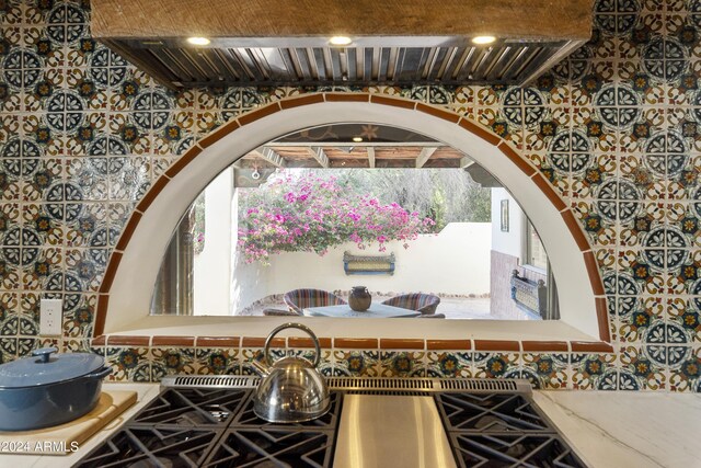 bathroom with tile patterned flooring, tile walls, and separate shower and tub