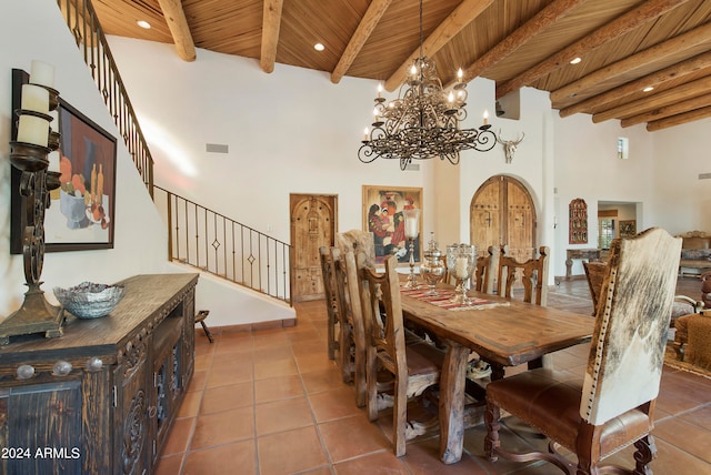 tiled dining space with beam ceiling, a notable chandelier, wood ceiling, and a towering ceiling