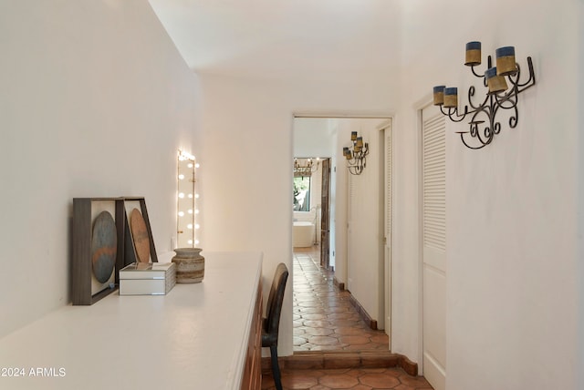 hall with tile patterned floors