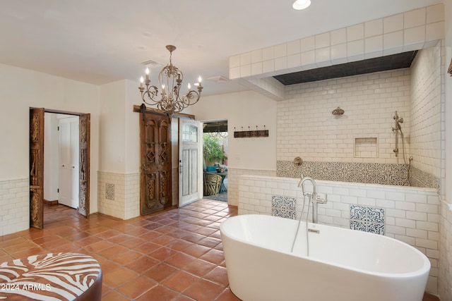 bathroom featuring an inviting chandelier, tile patterned floors, a bath, and tile walls