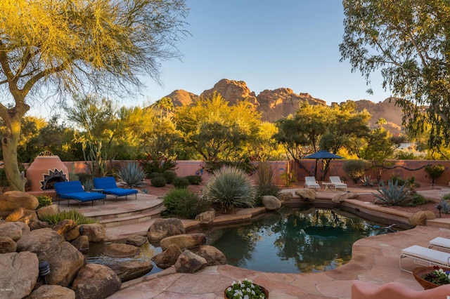 view of swimming pool featuring a mountain view and a patio