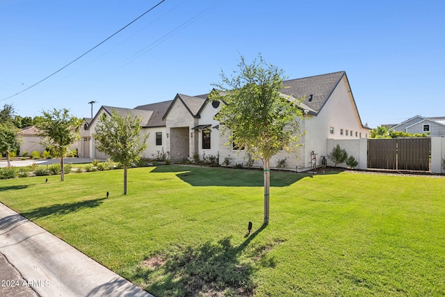 french country home featuring a front lawn