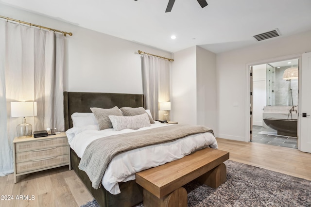 bedroom with hardwood / wood-style flooring, ceiling fan, and connected bathroom