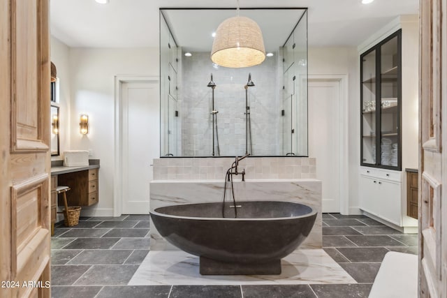 bathroom featuring separate shower and tub and vanity