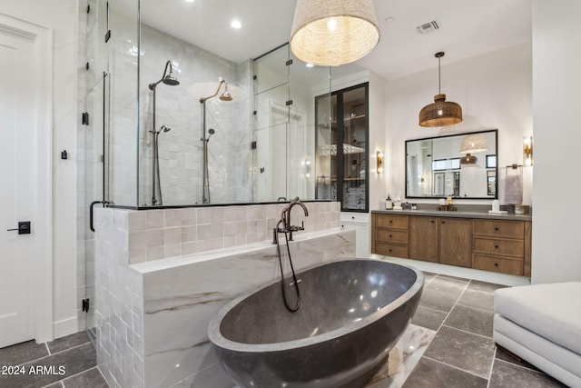 bathroom featuring separate shower and tub and vanity