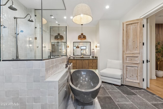 bathroom with separate shower and tub and vanity