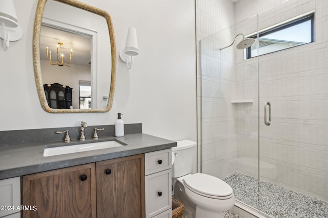 bathroom featuring toilet, walk in shower, and vanity