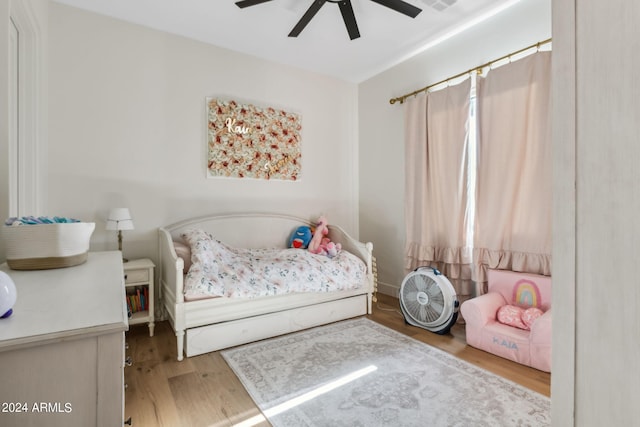 bedroom with ceiling fan and light hardwood / wood-style flooring