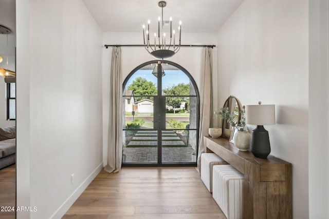 entryway with a notable chandelier and light hardwood / wood-style flooring