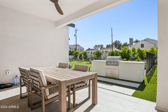 view of patio / terrace with exterior kitchen, ceiling fan, and a grill