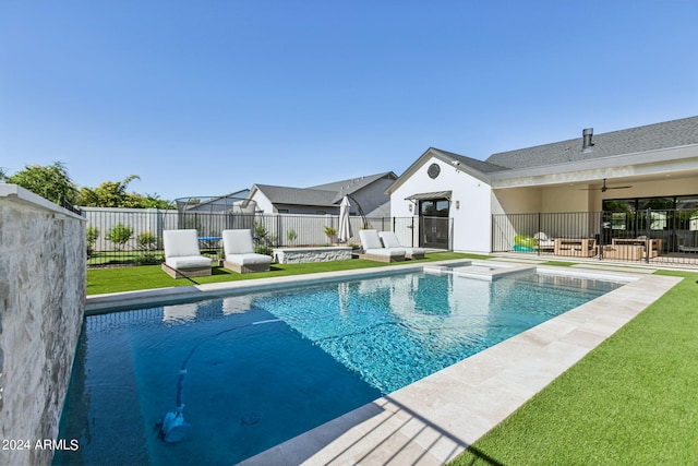 view of pool with ceiling fan, a patio, and a lawn